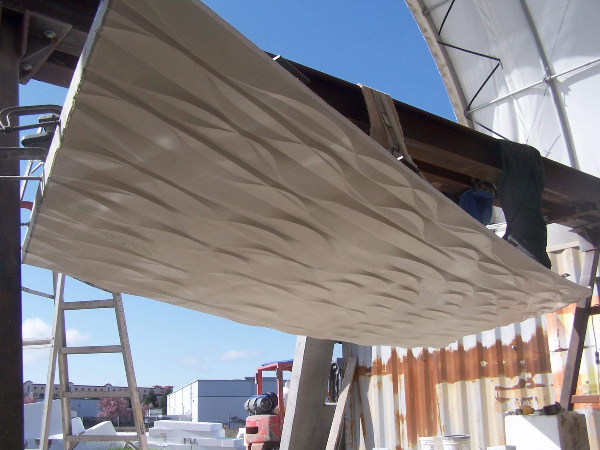 Accoustic panel being lifted by a small crane